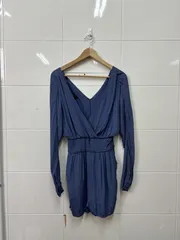 Navy wrap dress photographed on a hanger